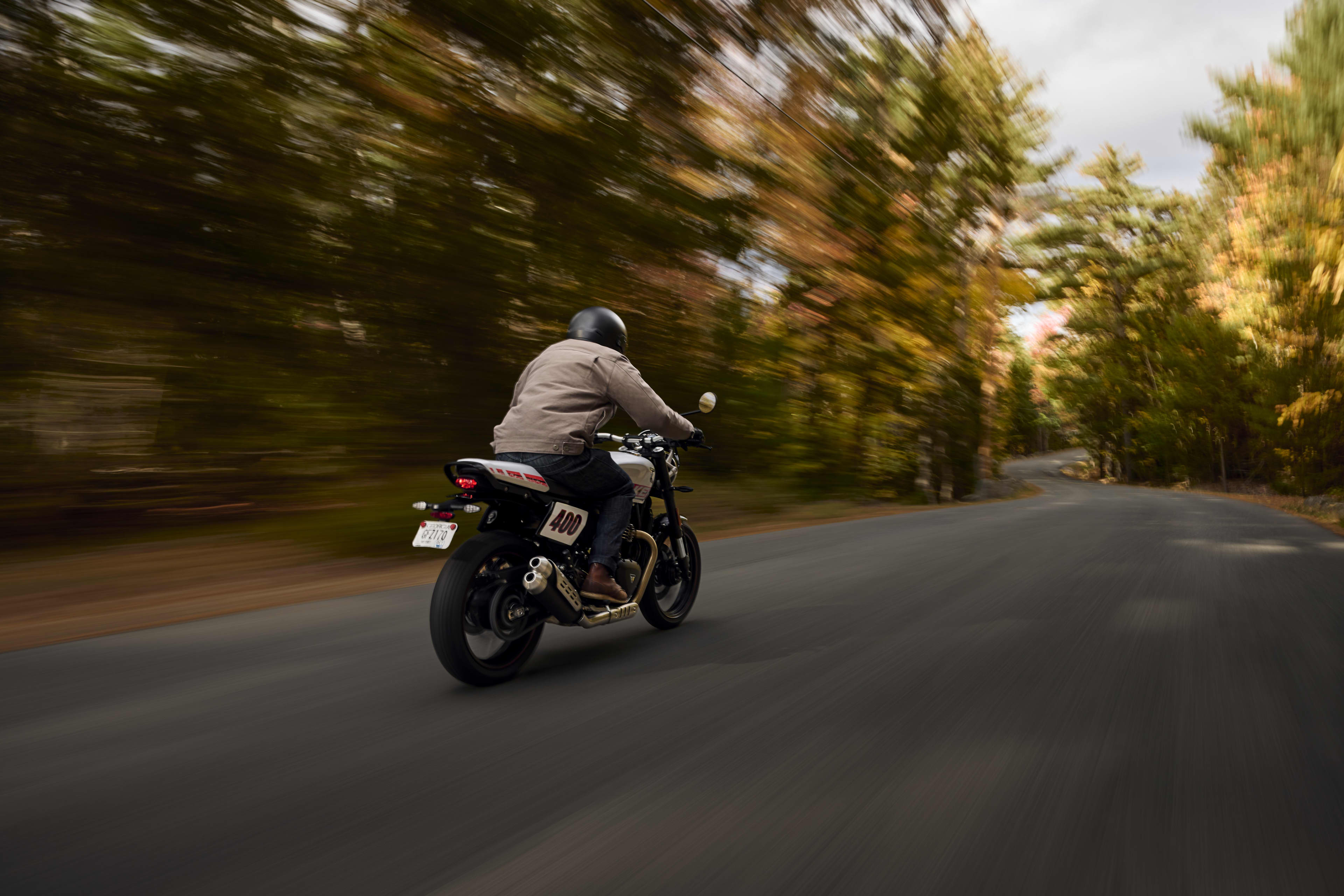 Back right side riding shot on a road in a forest