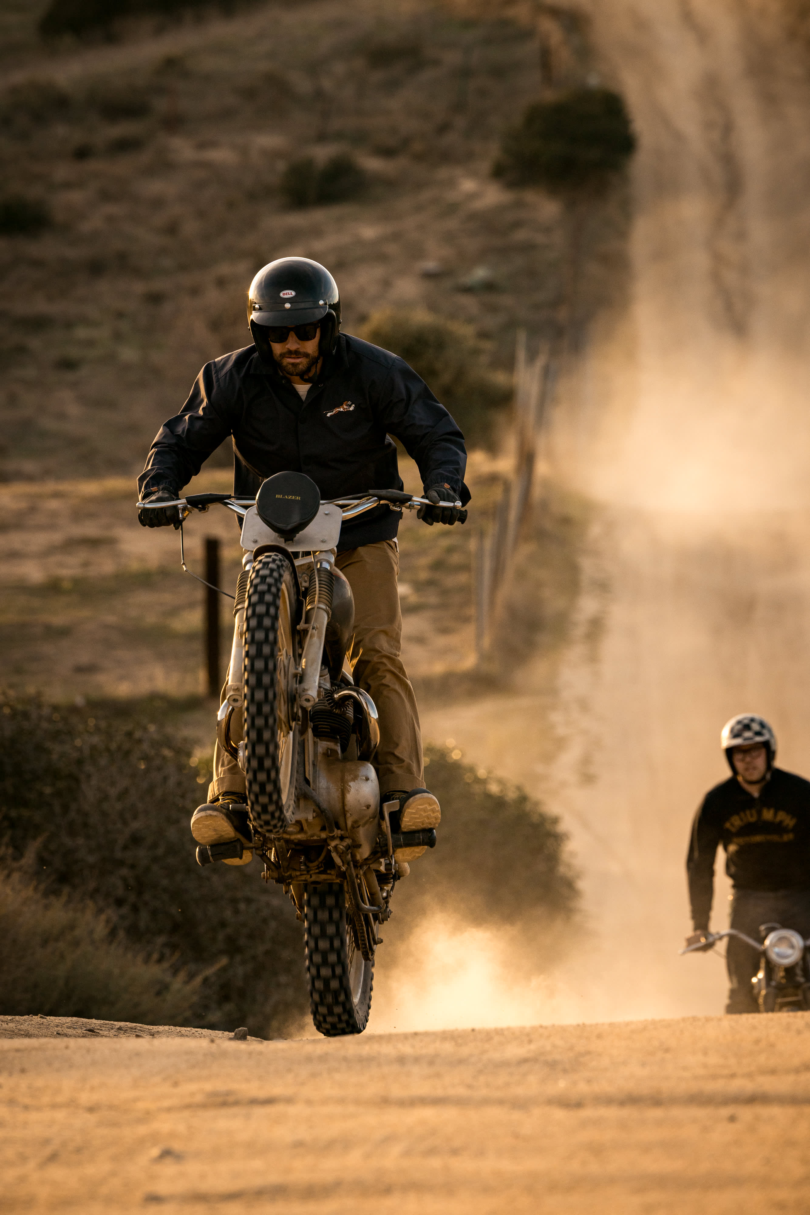 Man riding motorbike wearing Triumph Motorcycles Coach Jacket