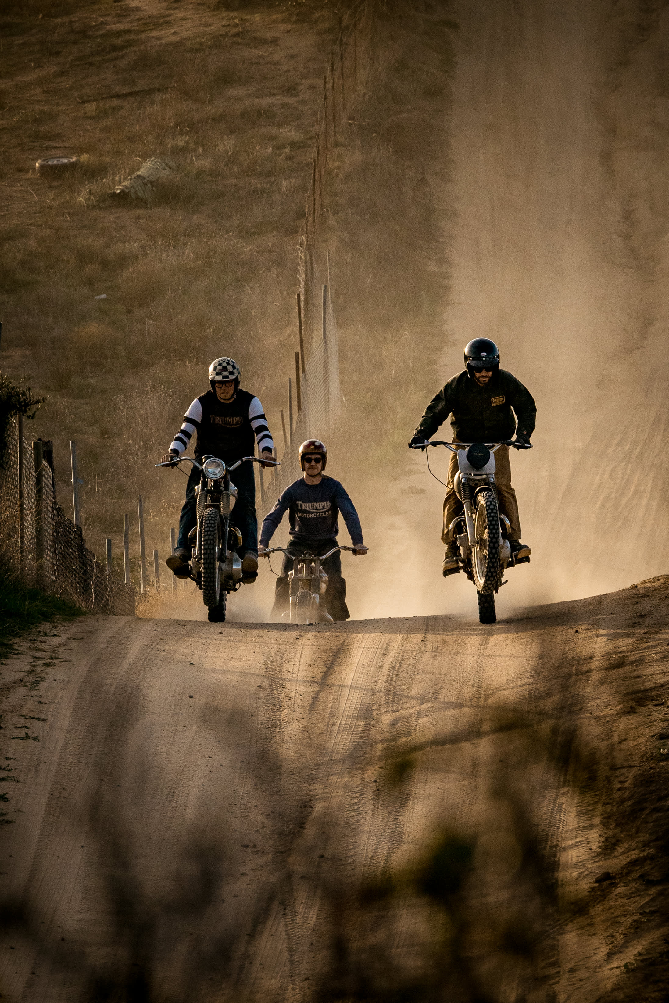 Three men riding their Triumph Motorcycles in the desert