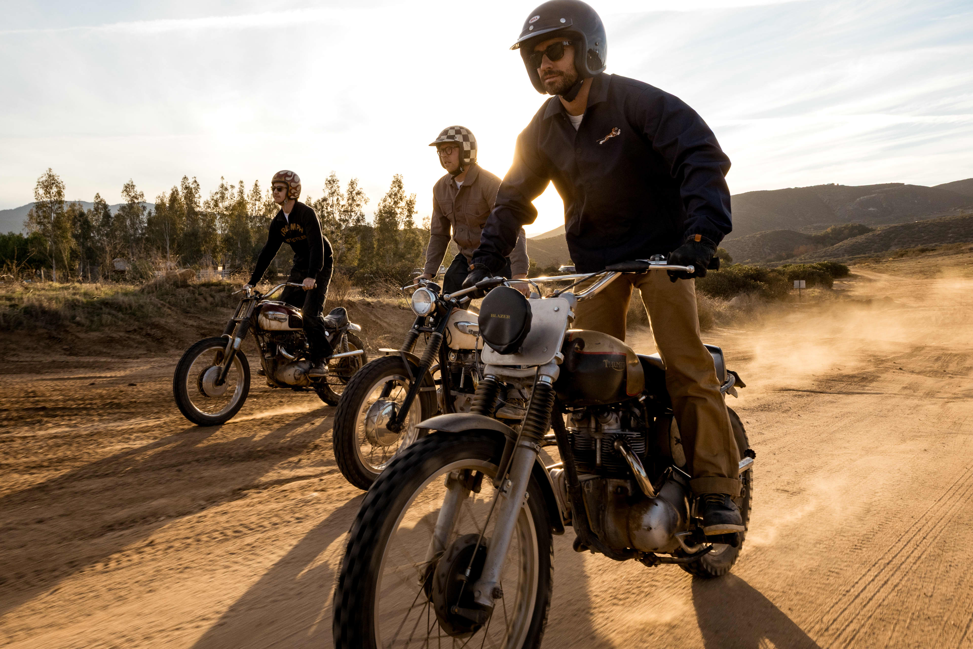 Three men riding Tirumph Motorcycles wearing Triumph Heritage Clothing