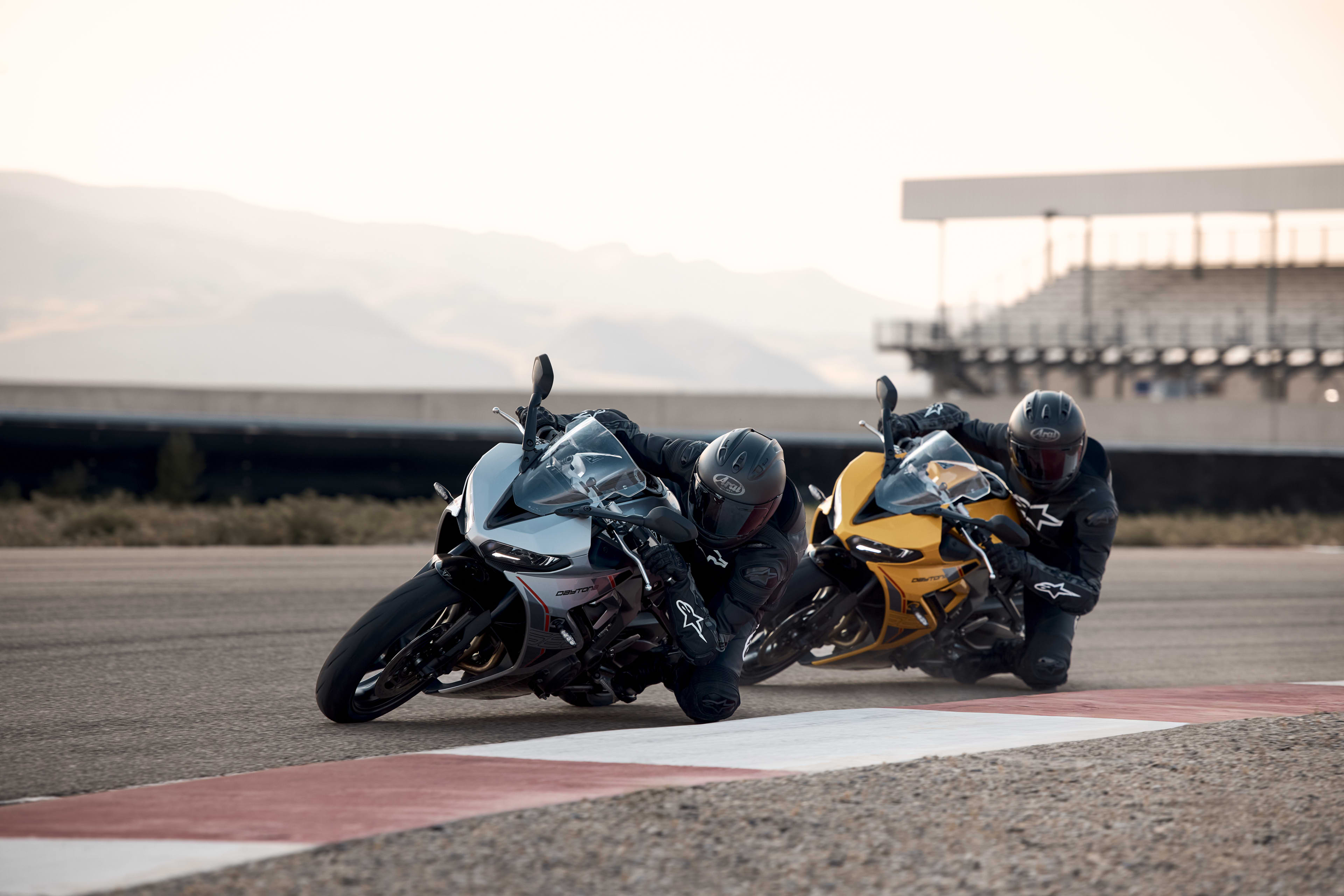 Left side angled action shot of two riders on Triumph Daytona 660