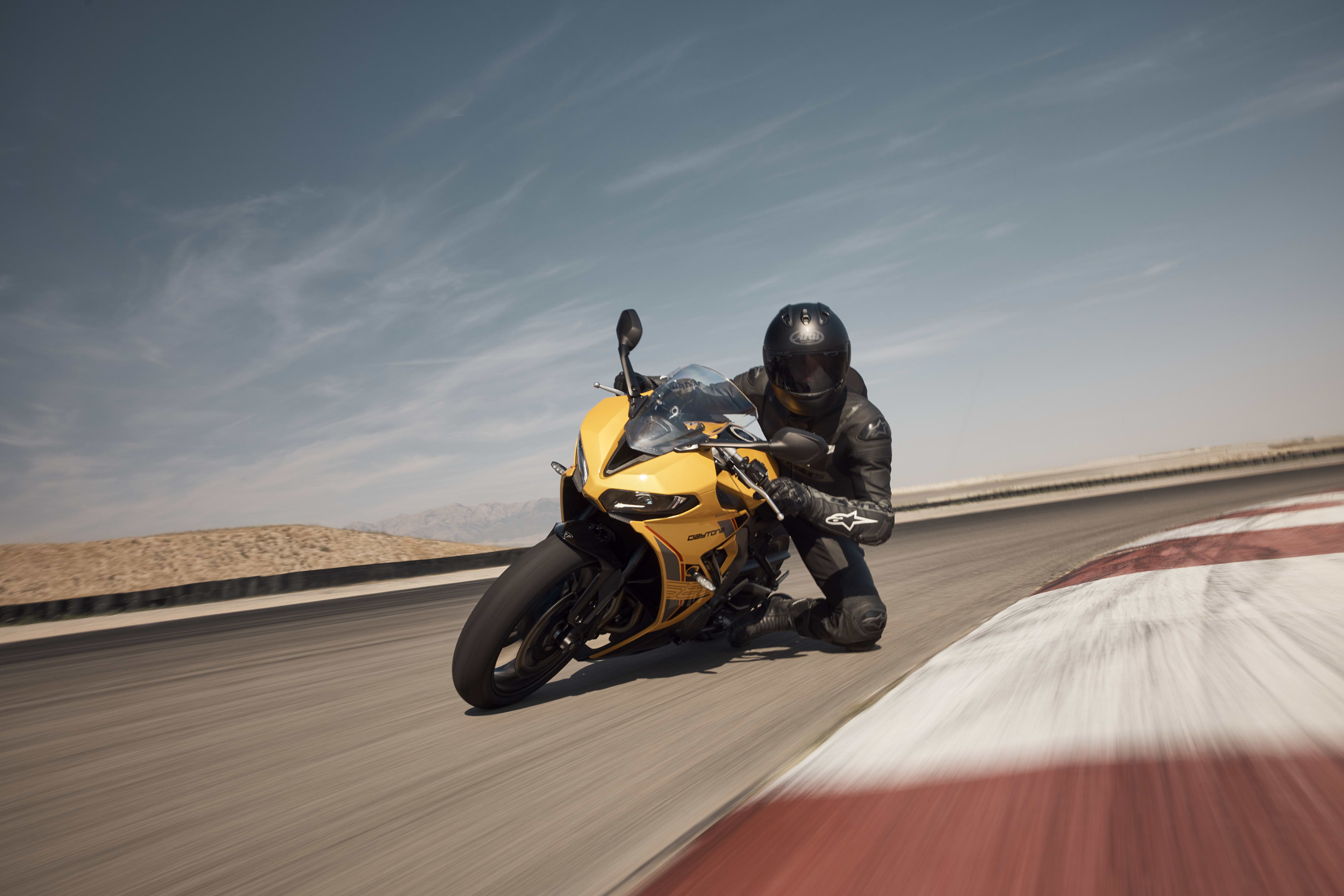 Angled front side action shot of rider on Triumph Daytona 660