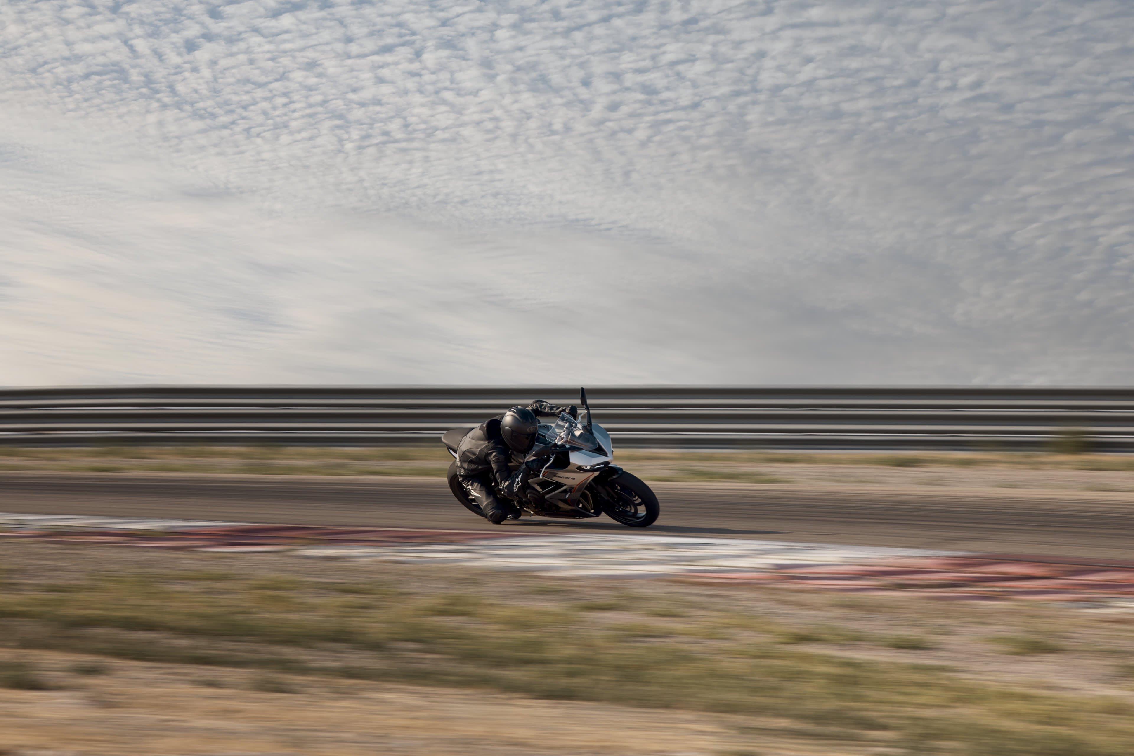 Angled front side action shot of rider on Triumph Daytona 660
