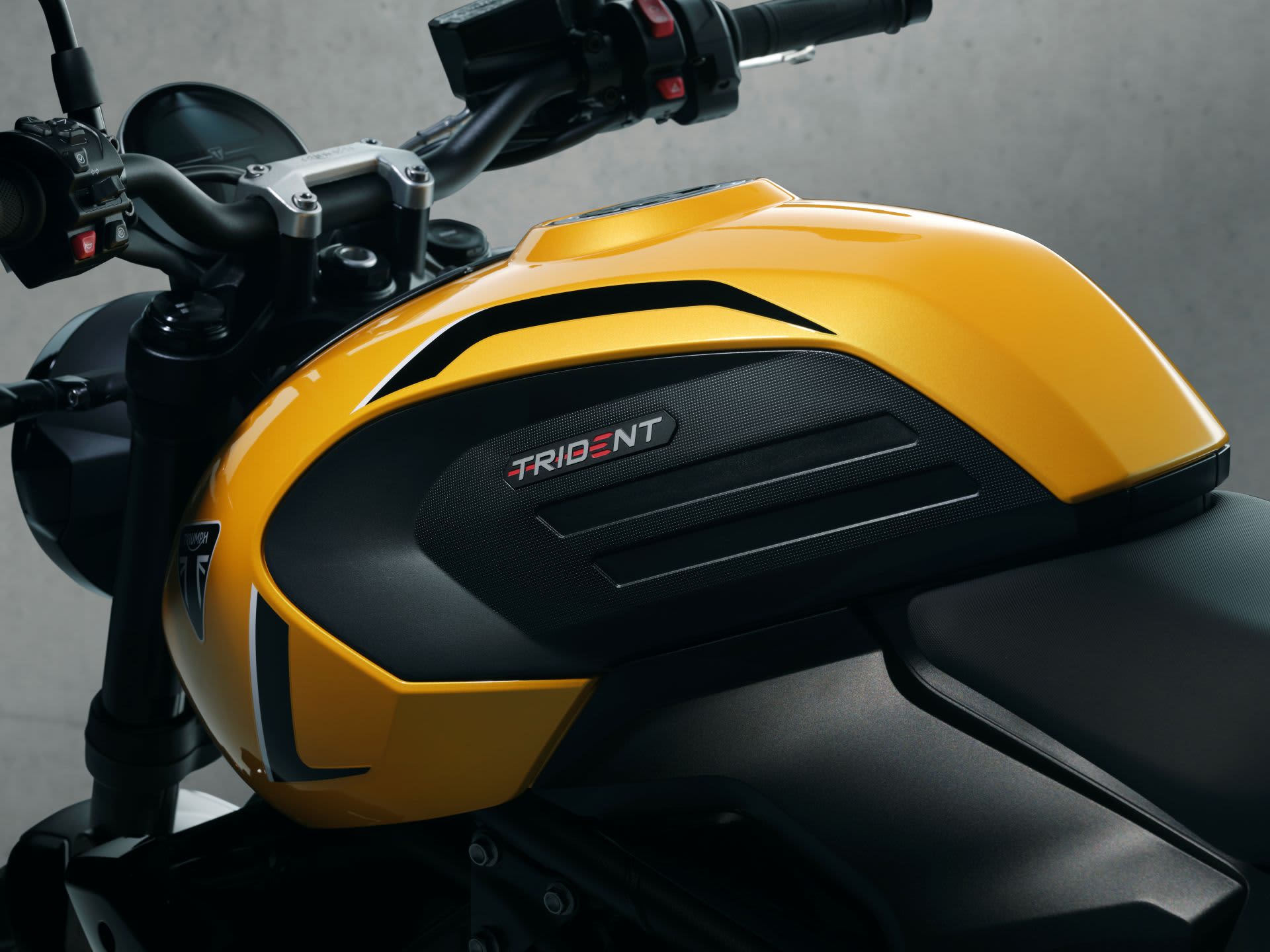 Lineup of three Triumph 660 motorcycles: a Tiger Sport, a Trident and Daytona.