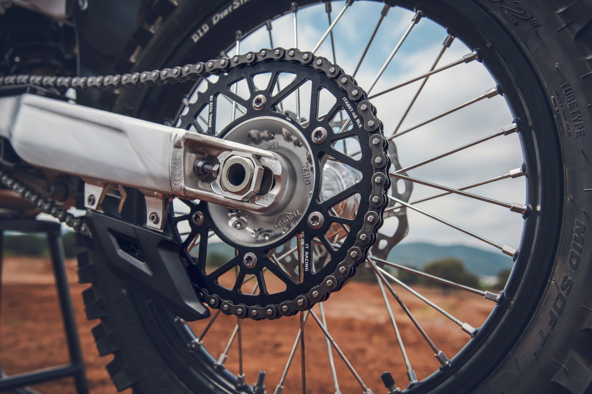 A close up of a Triumph TF 450-X off-road bike rear wheel.