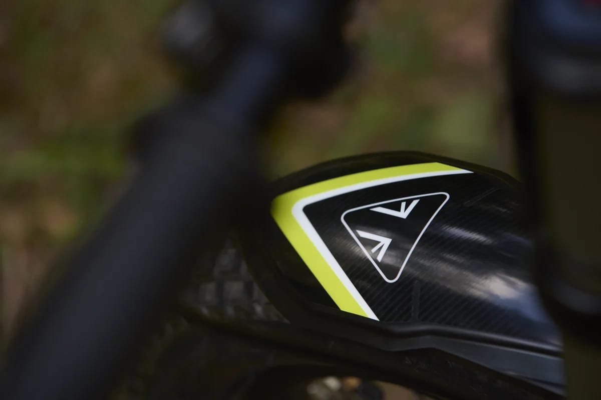 Close-up view of the Triumph logo decal on the front mud guard of a TXP-20 youth motorcycle.