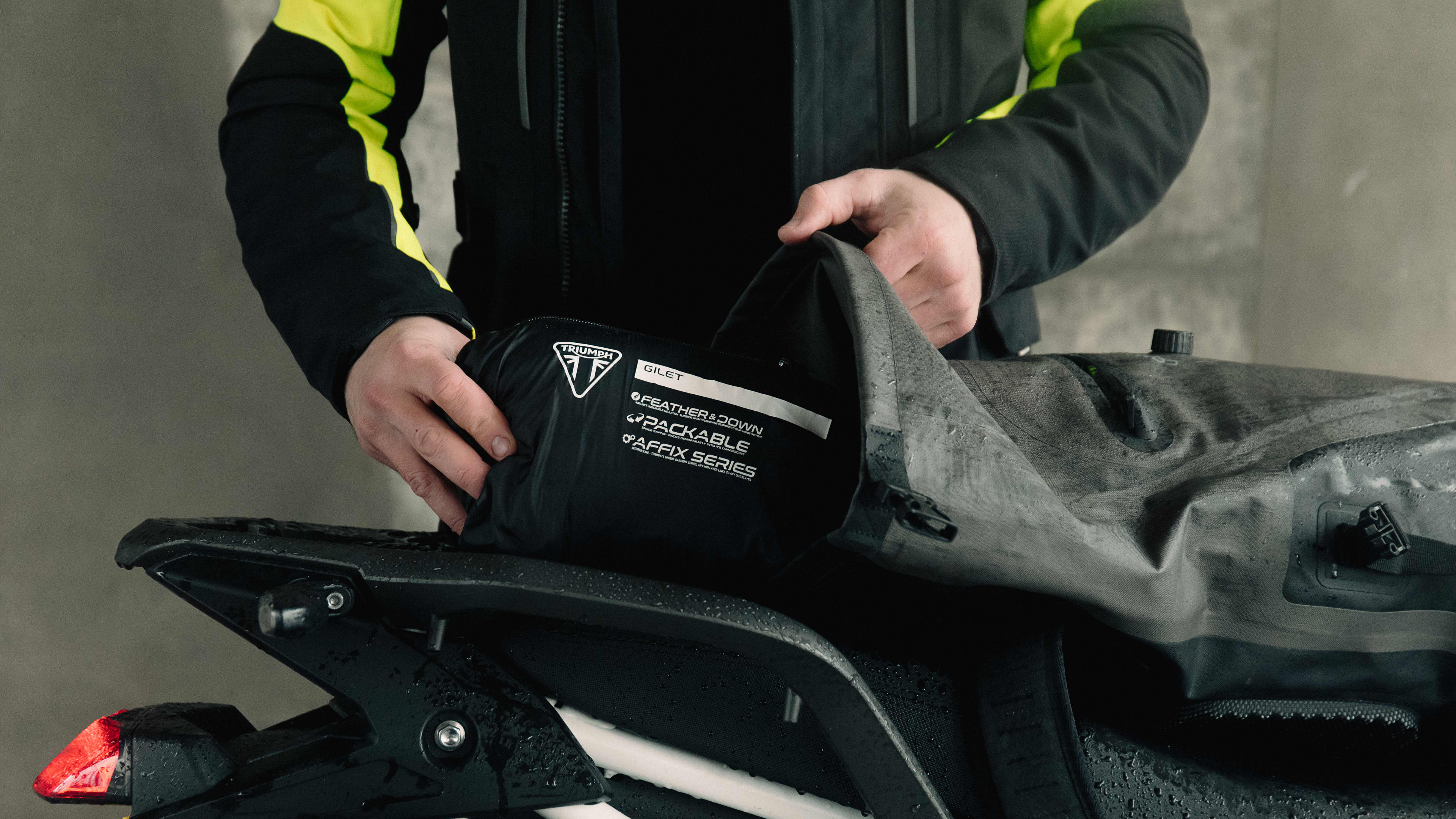 Triumph blue racing checkerboard long sleeve t-shirt on a rock