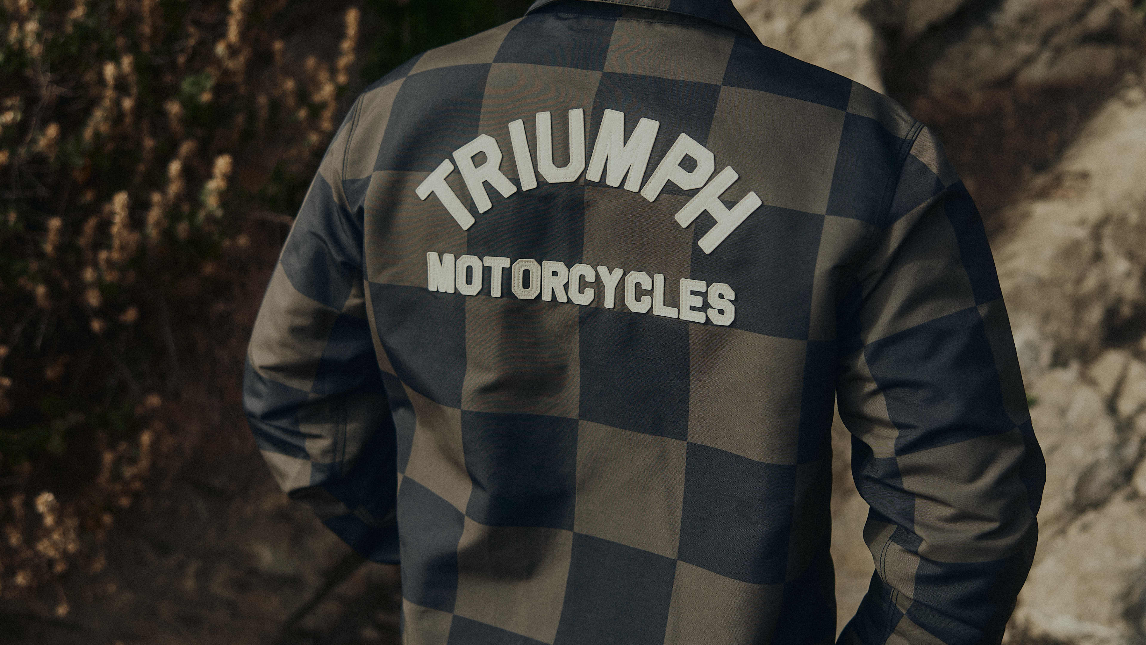 Man wearing the checkerboard coach jacket