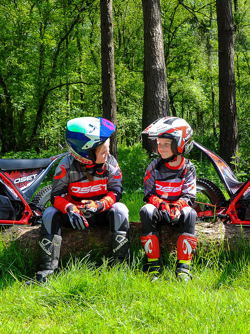 OSET Two children sitting in front of the OSET electric bikes