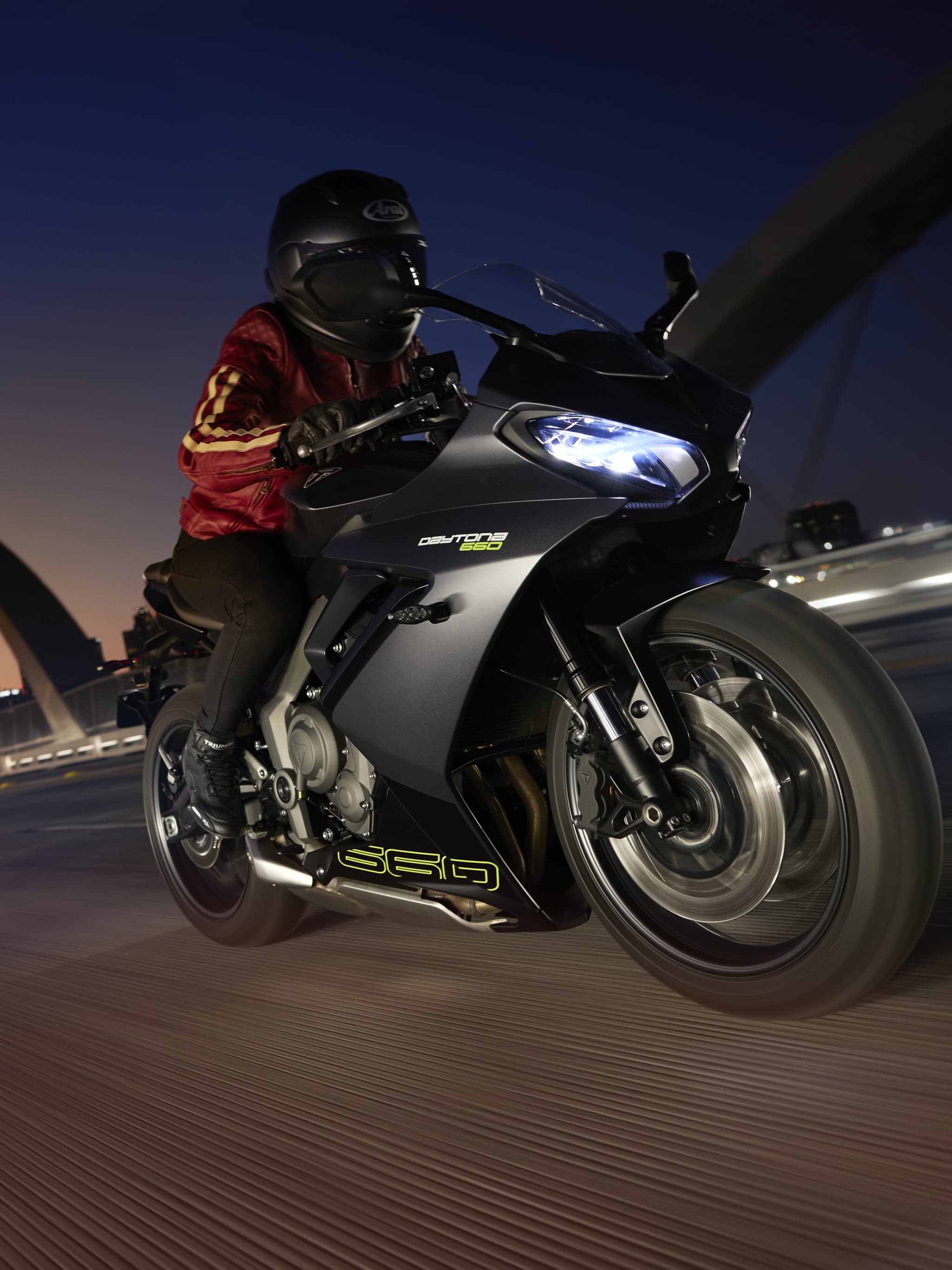 Rider on Triumph Daytona 660 in Satin Granite / Satin Jet Black with a sunset in the background