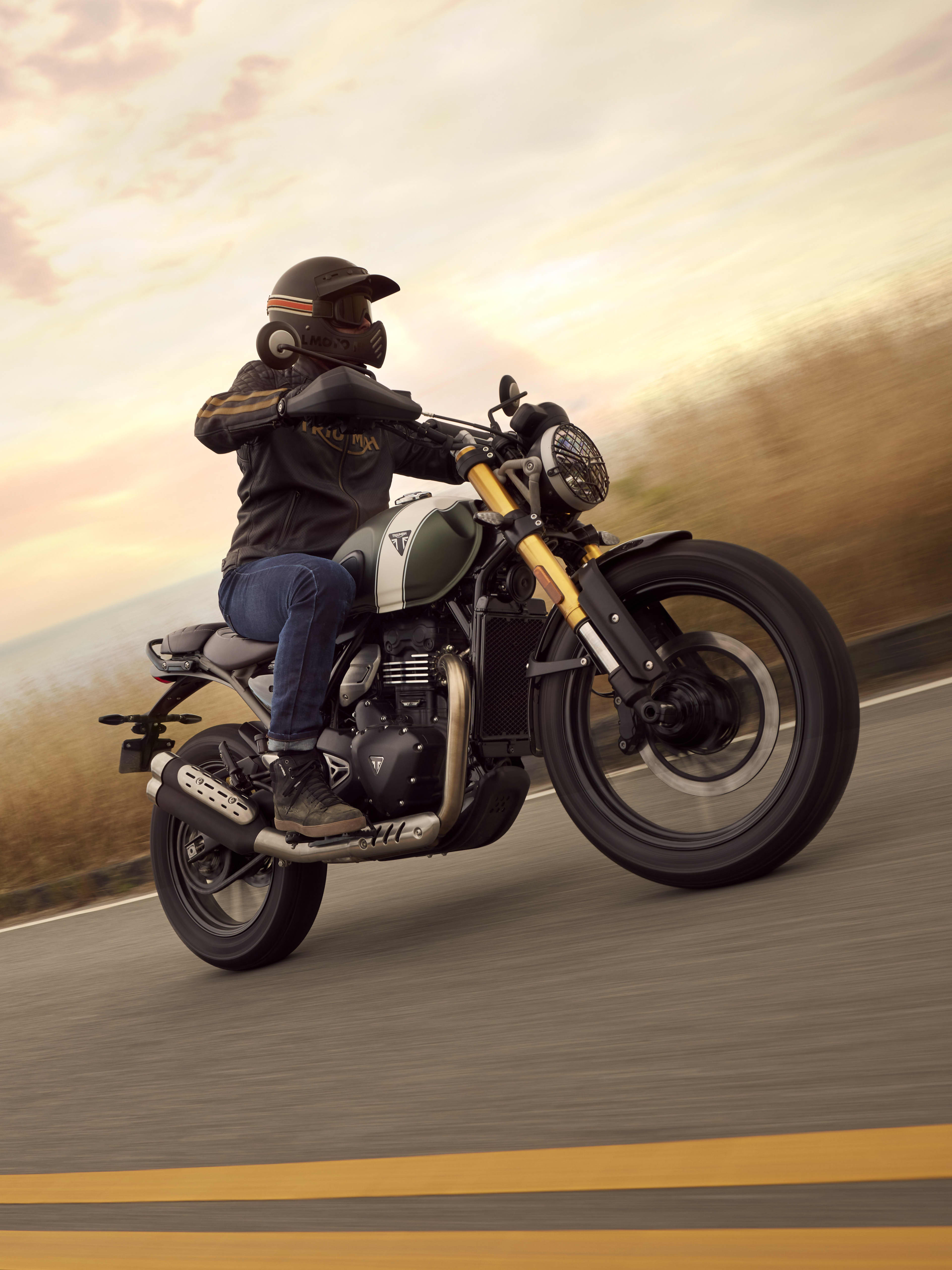 Triumph Scrambler 400 X riding round a bend on the road