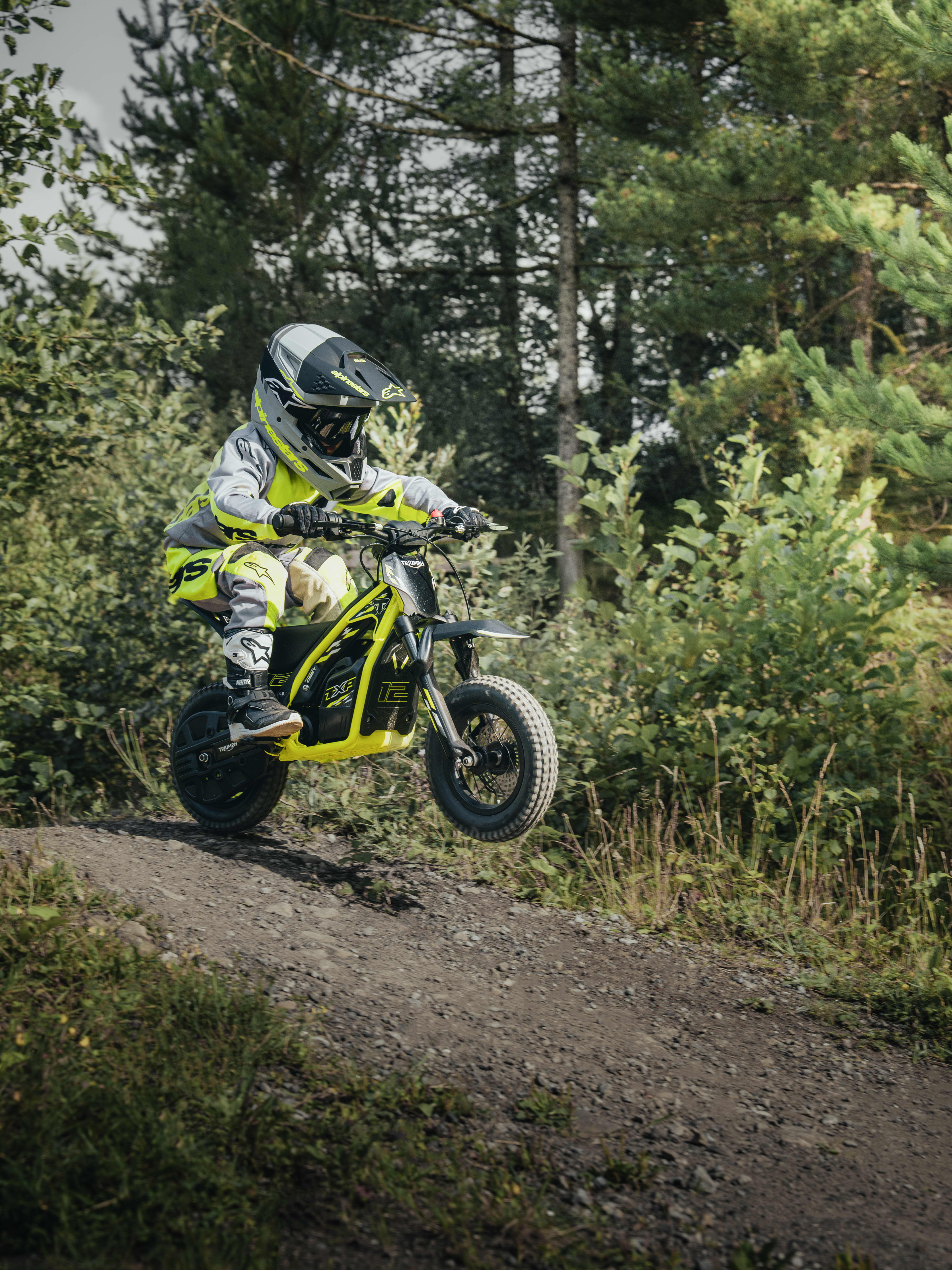 TXP-12 powered by OSET bike going down a small slope in a forest.