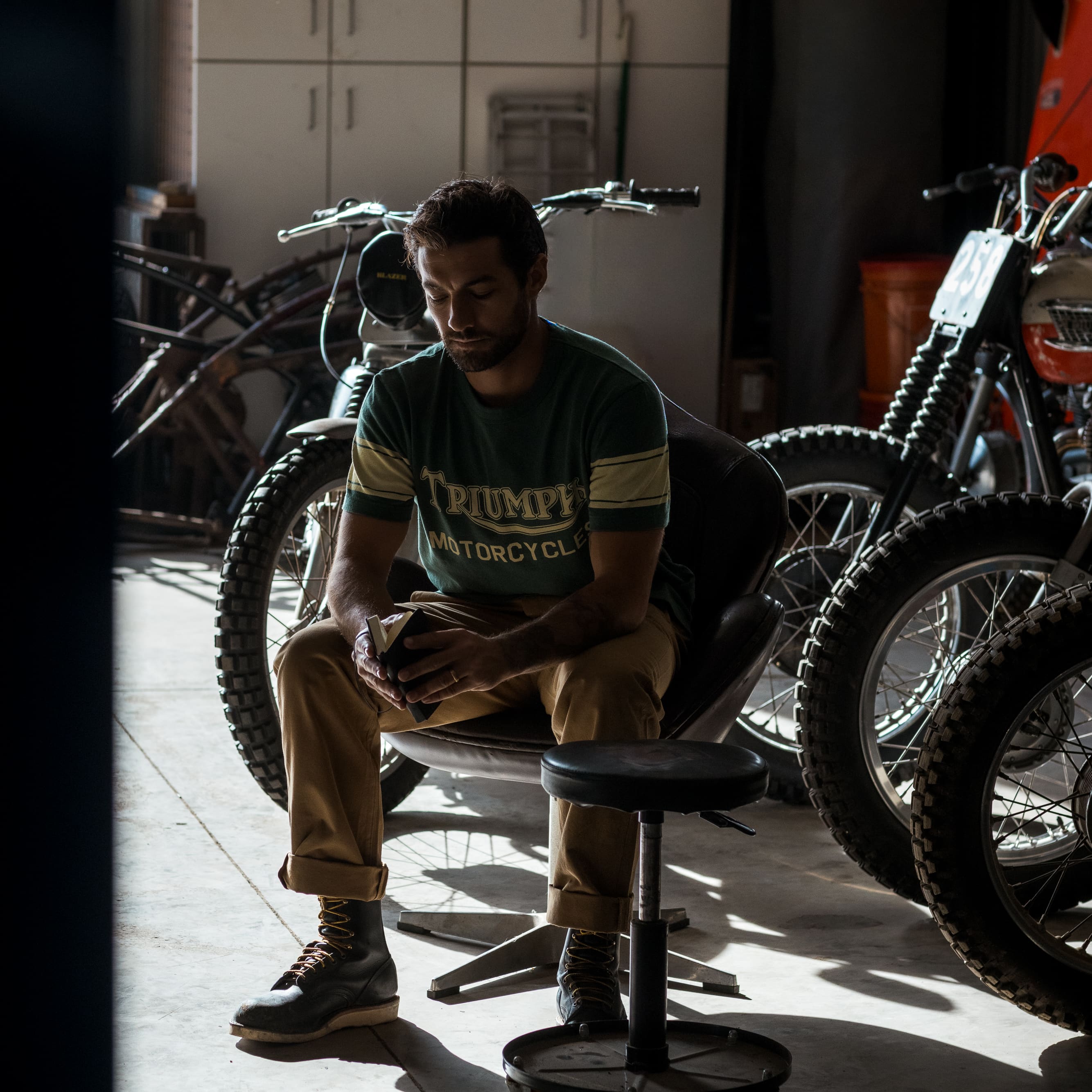 Man wearing a green Triumph Motorcycles T-shirt