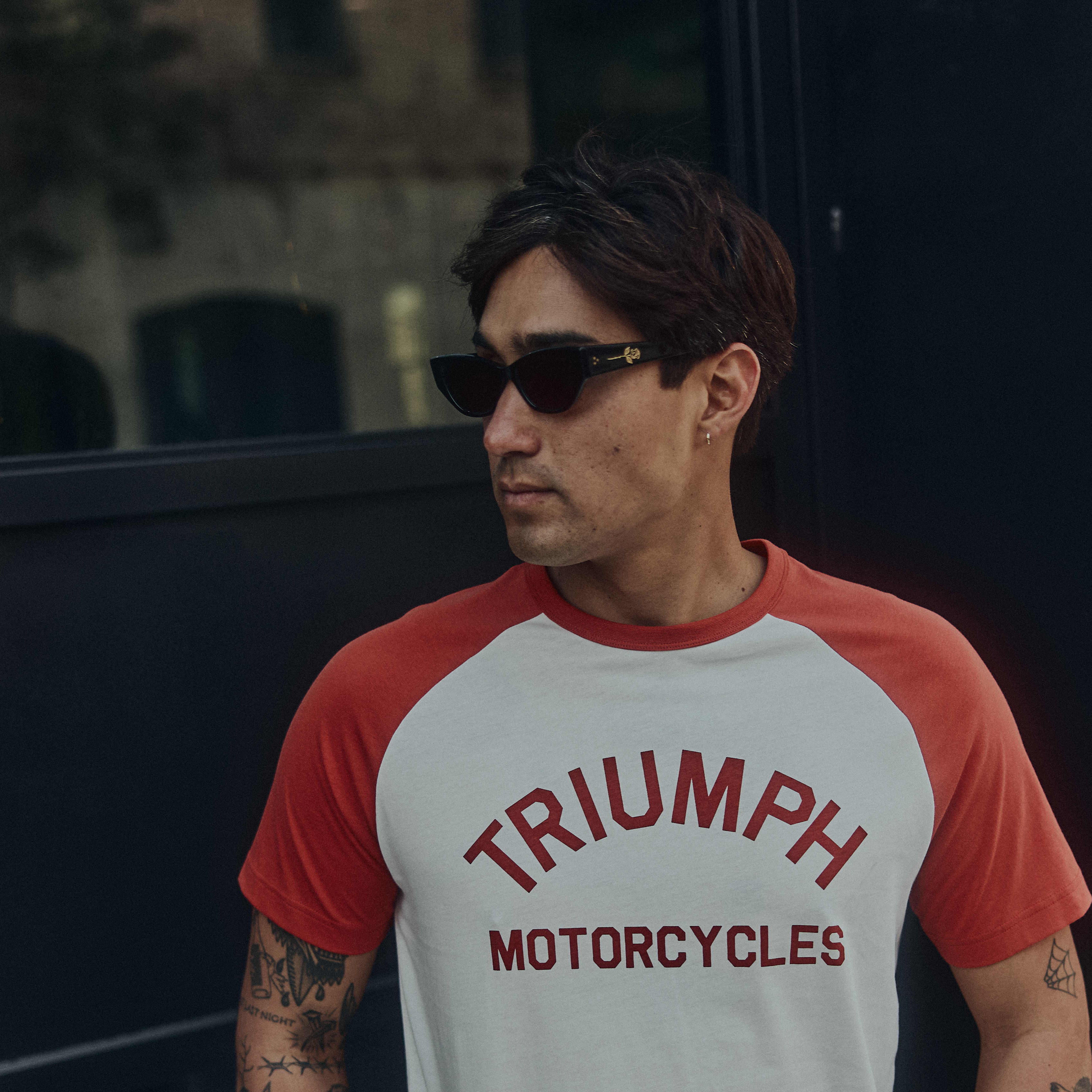 Man stood in street wearing Triumph clothing