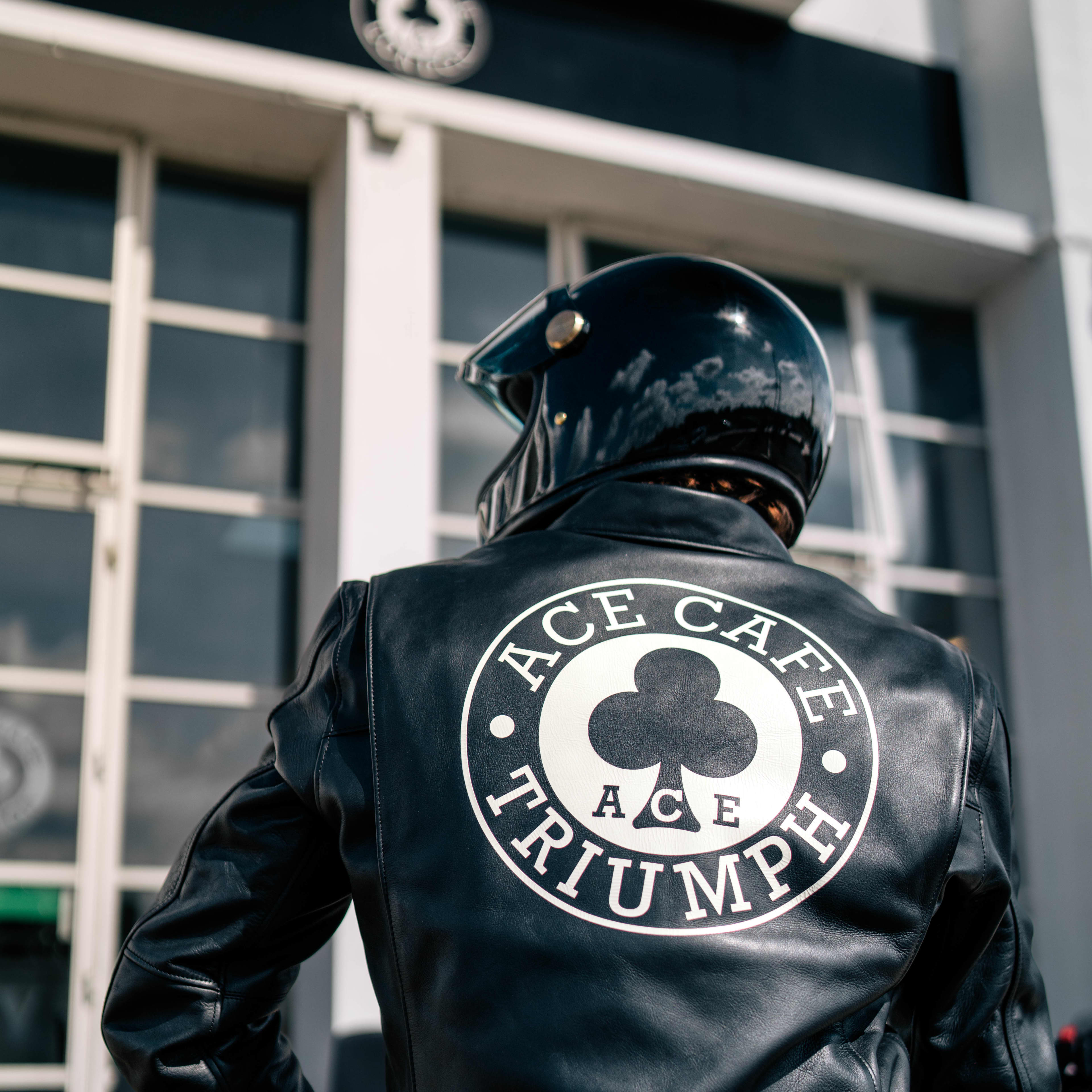 A man wearing a Triumph x Ace Cafe Leather Jacket