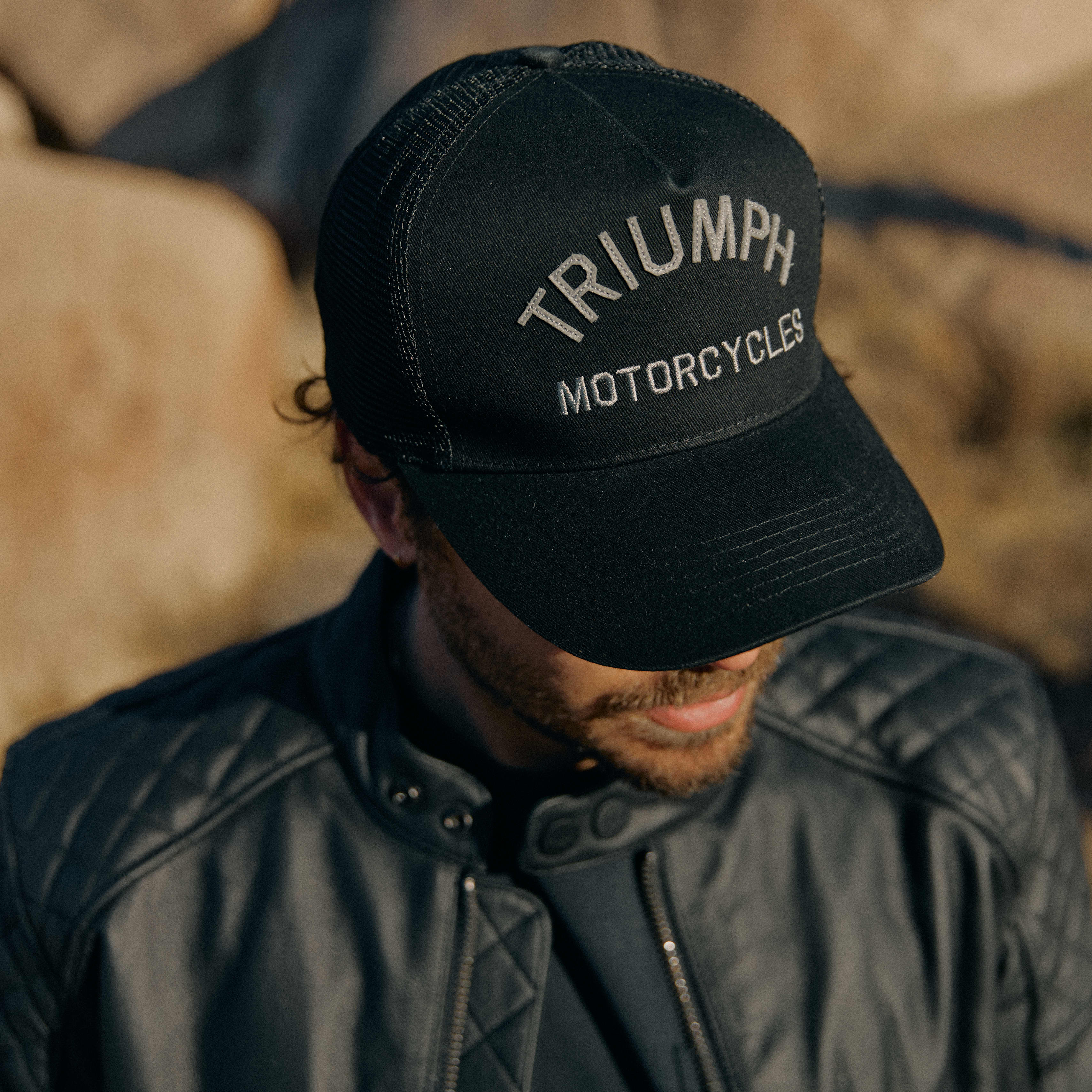 Man in jacket wearing black Triumph Motorcycles Cap