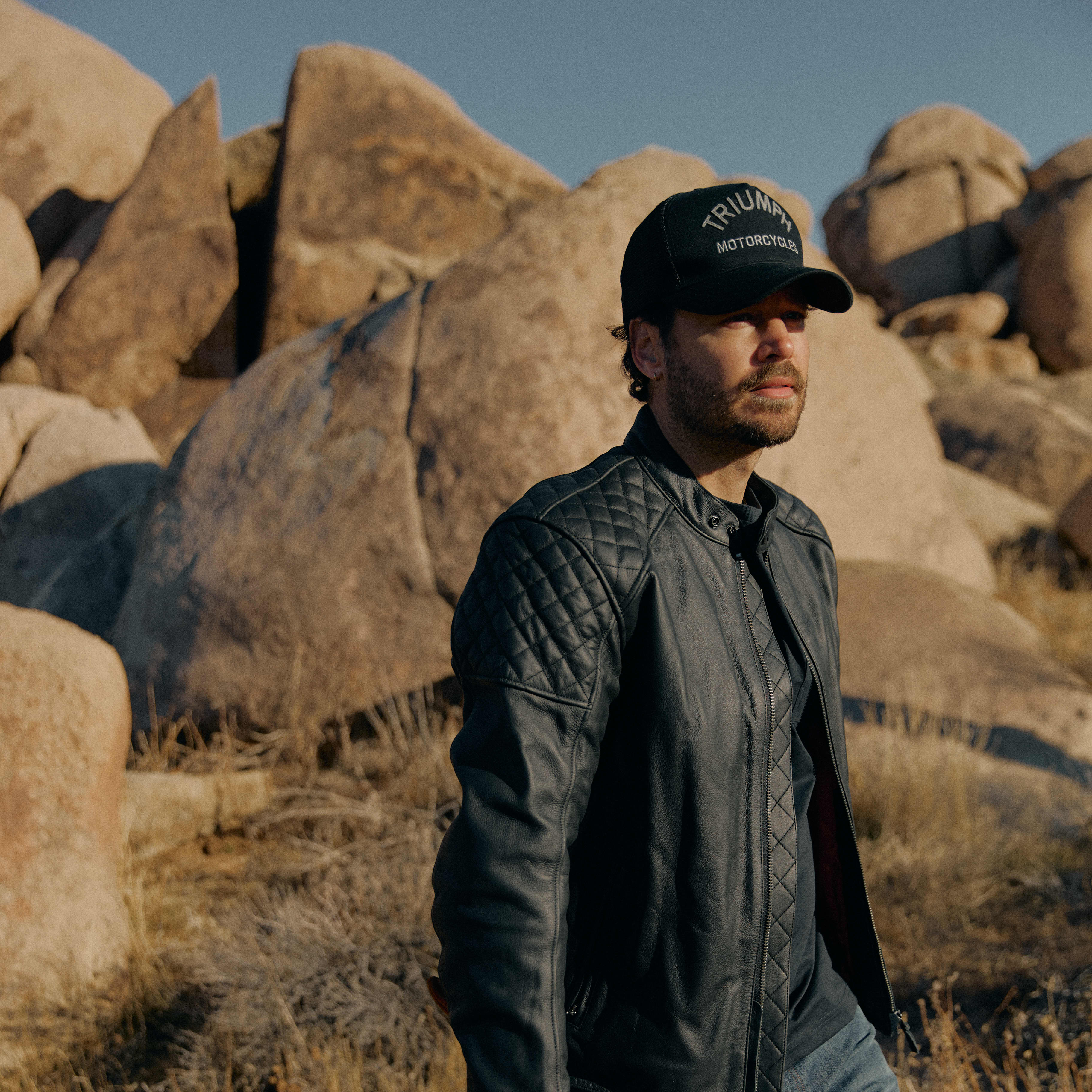 Man walking wearing triumph jacket
