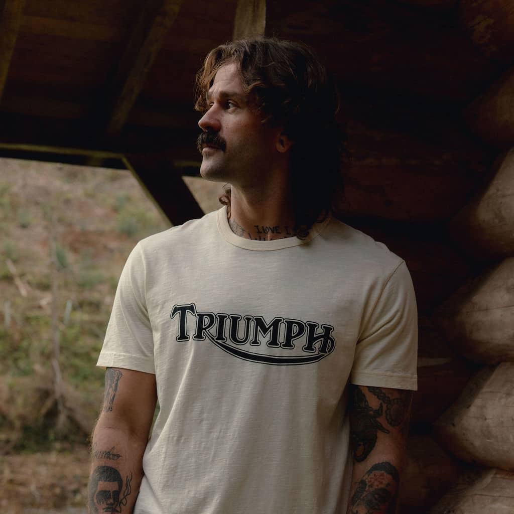 Man outside cabin wearing a Triumph Motorcycles T-shirt