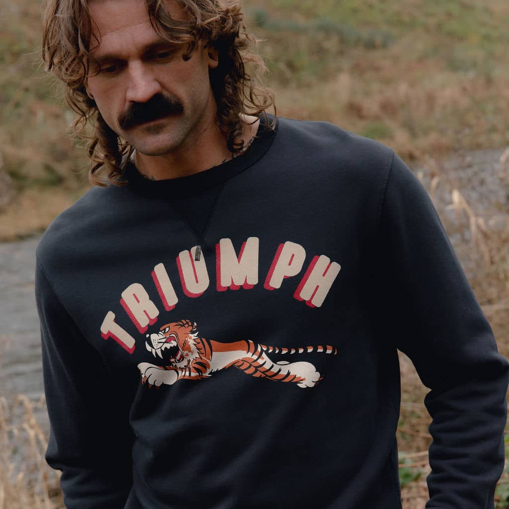 Man wearing a Triumph and leaping tiger sweatshirt