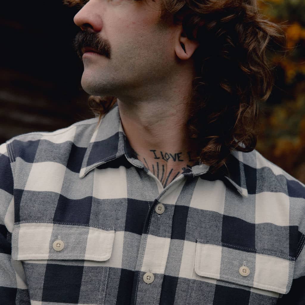 Close up of man wearing checker white and black shirt