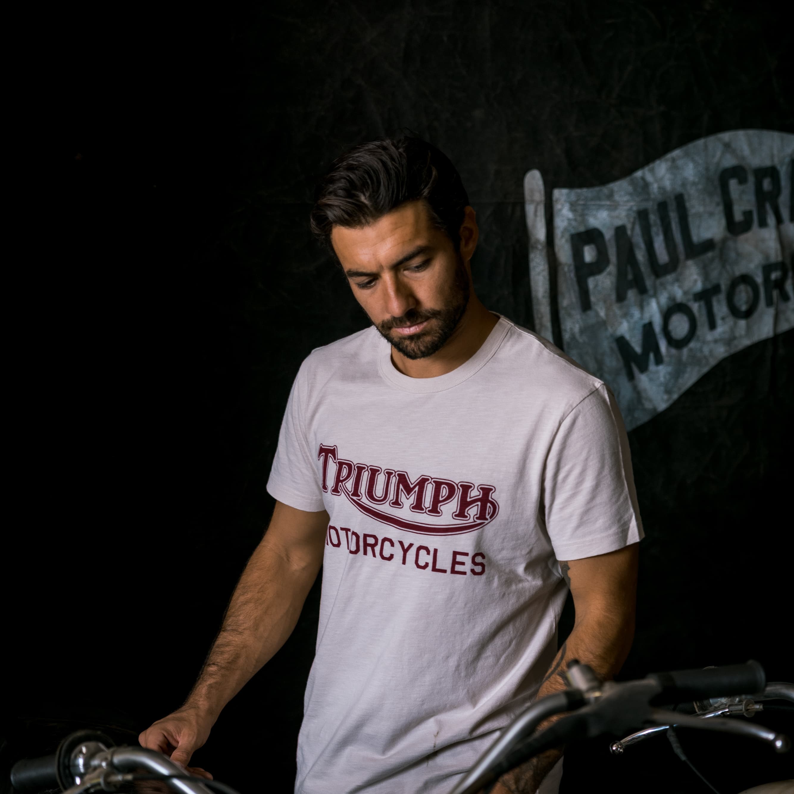 Man in workshop wearing a Triumph Heritage t-shirt