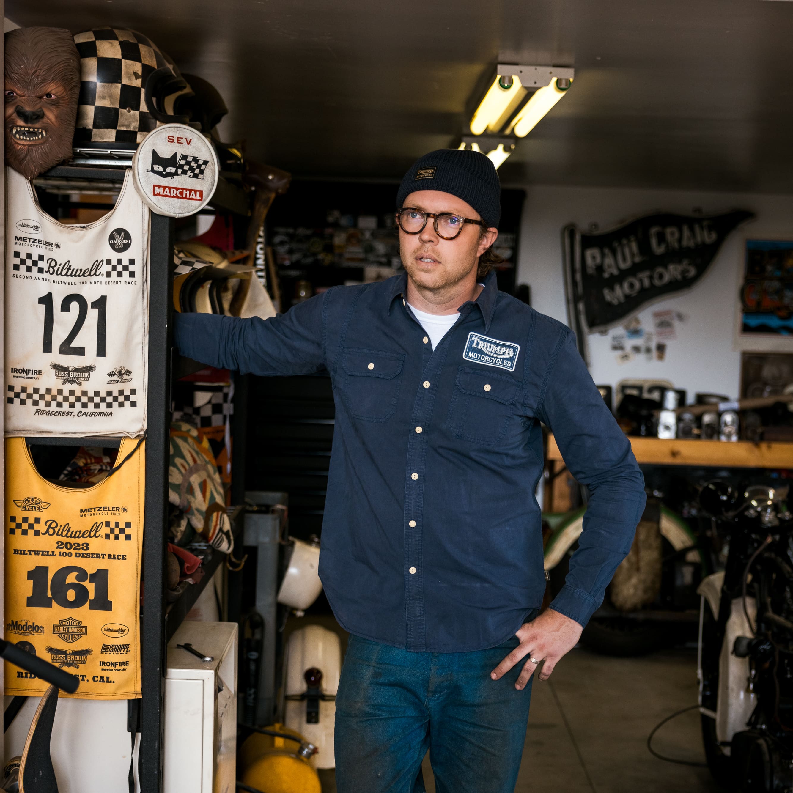 Man looking in the distance wearing a camo Triumph Heritage Jacket