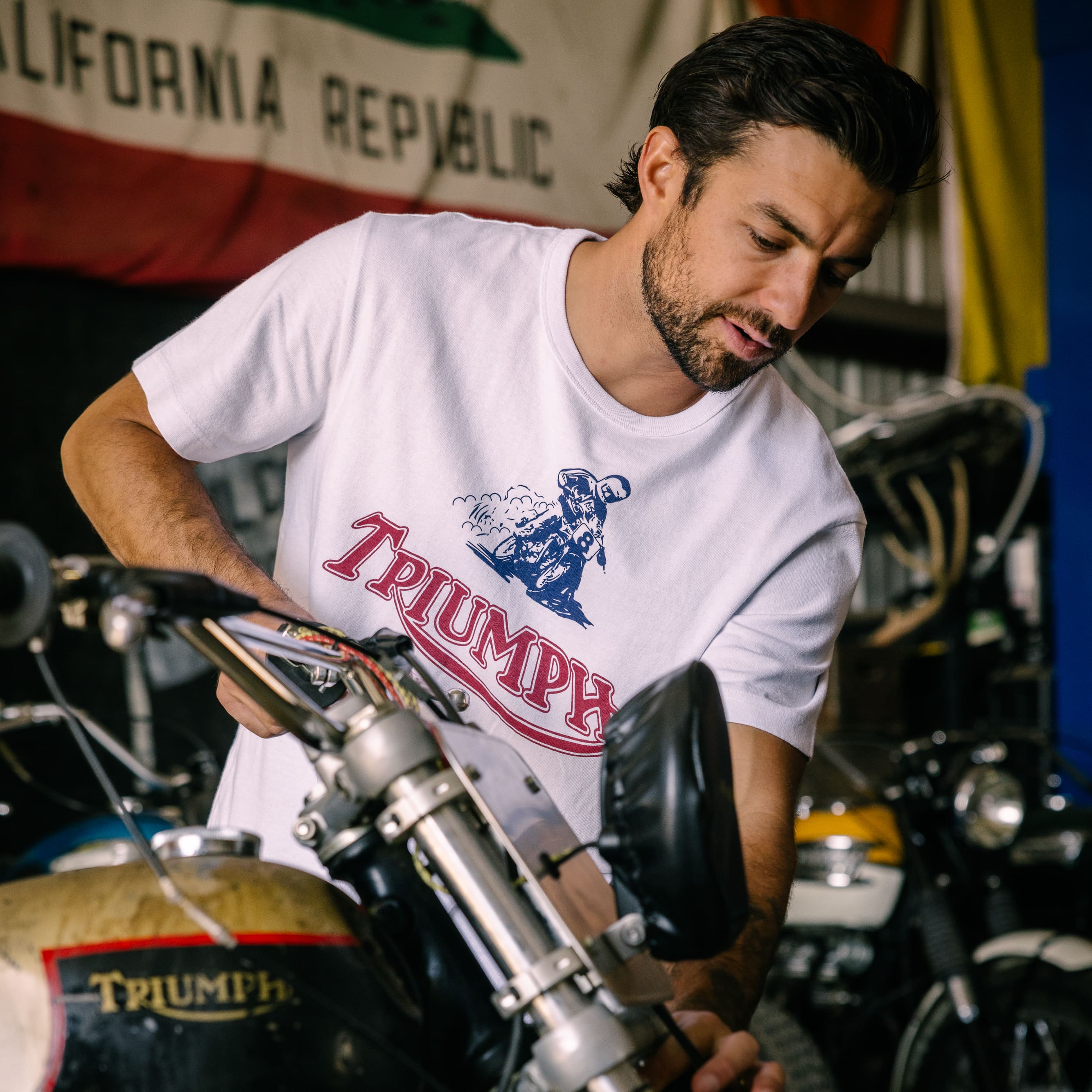 Man in white Triumph Motorcycles t-shirt