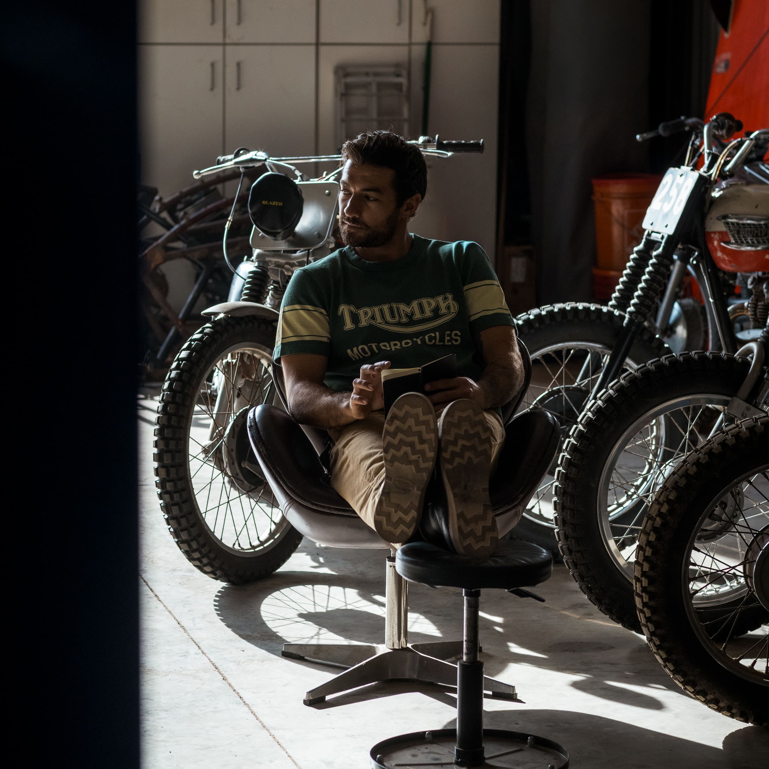 Man wearing a green Triumph Motorcycles T-shirt