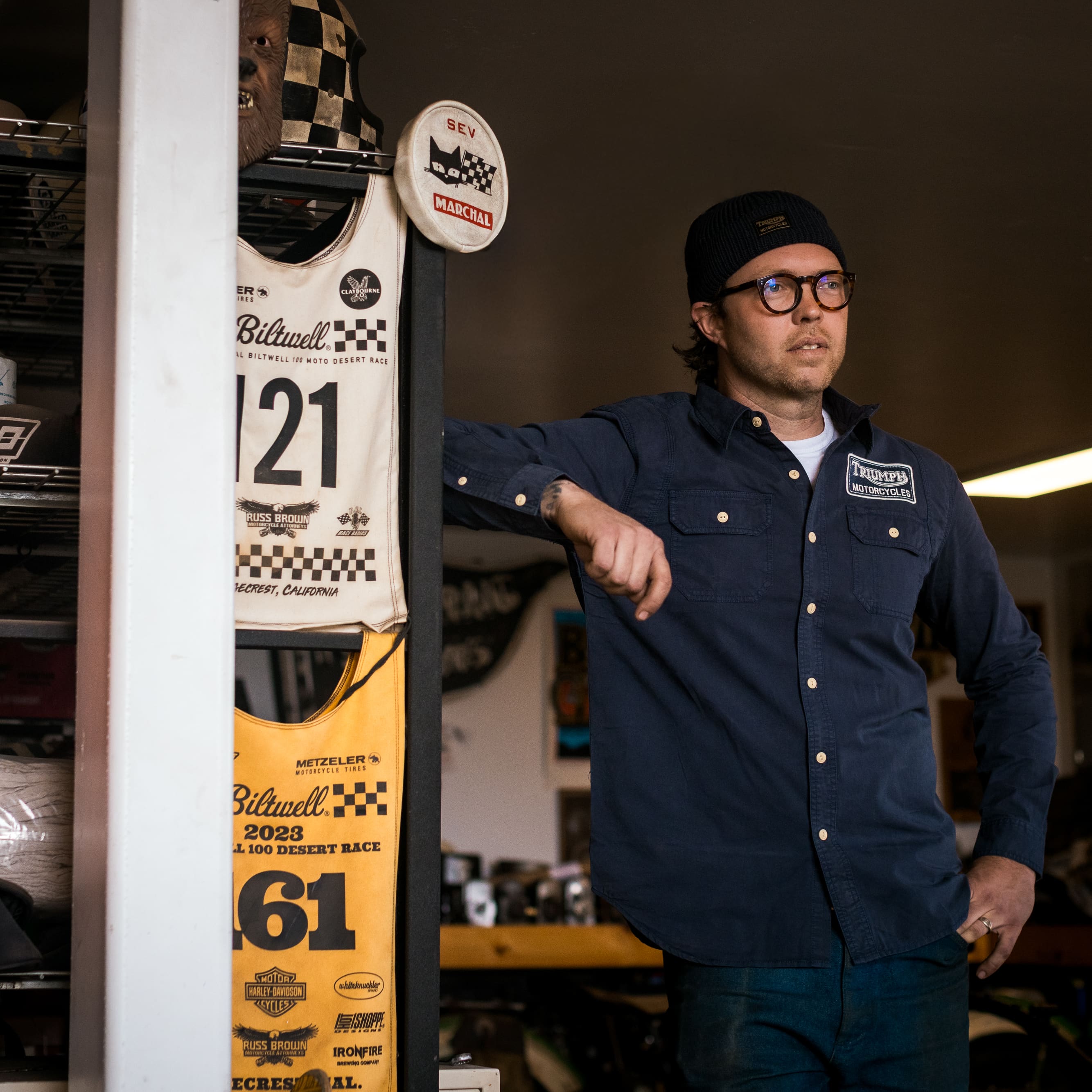 Man in motorbike garage wearing a Triumph Heritage Shirt