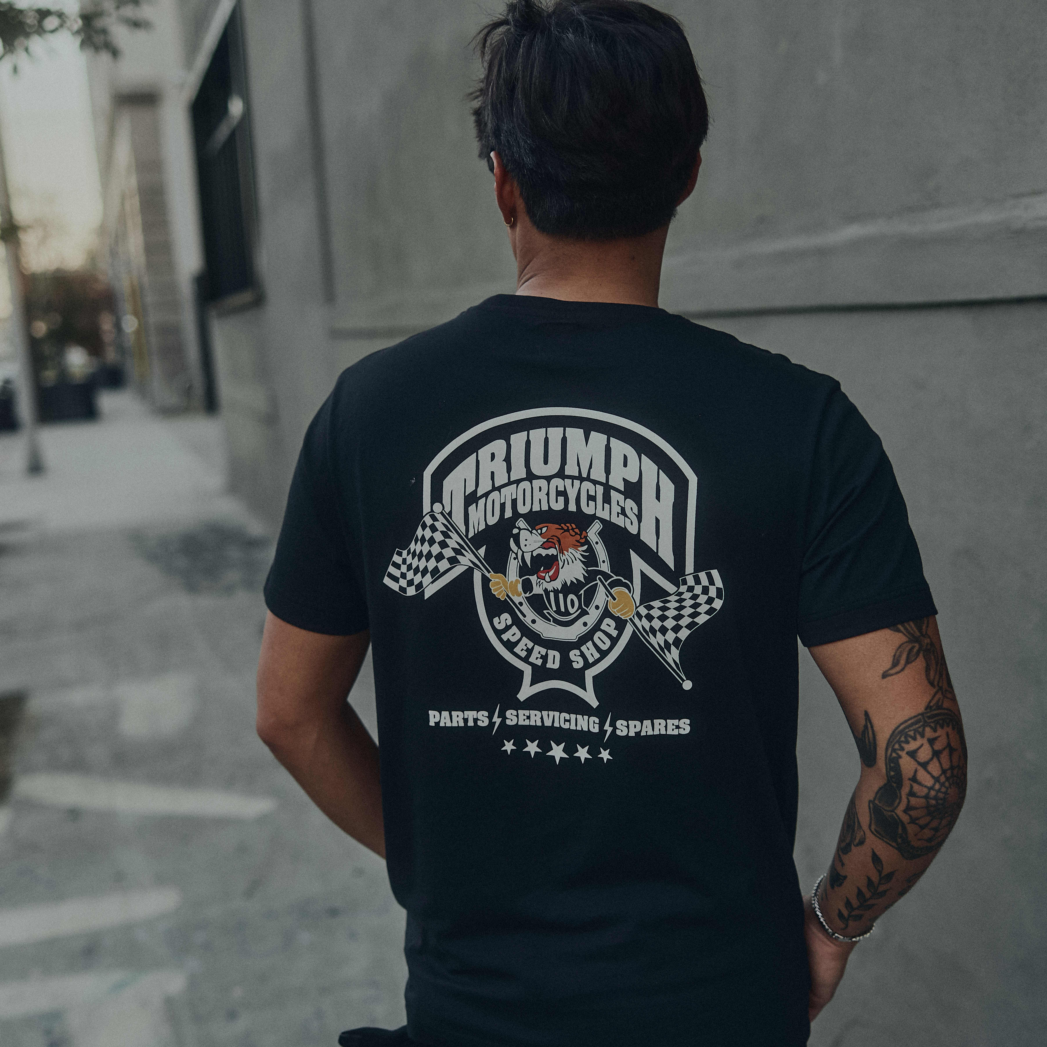 Man in the desert wearing a white Triumph Motorcycles T-shirt