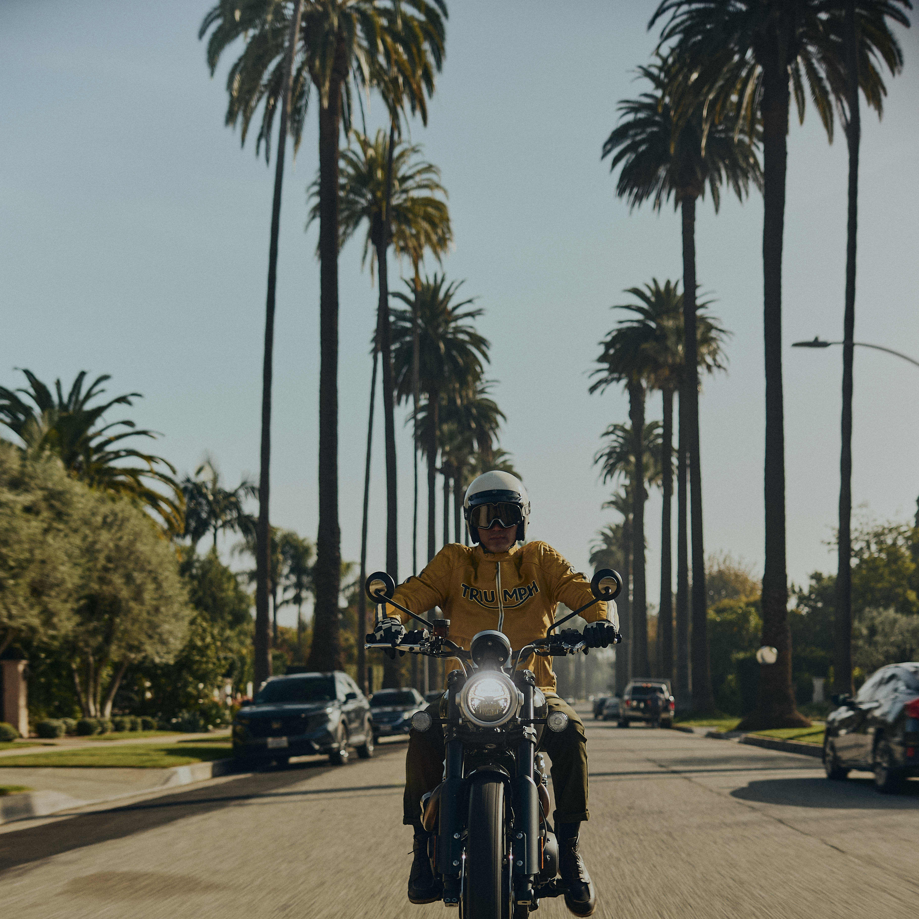 Man stood next to triumph bike wearing triumph riderwear