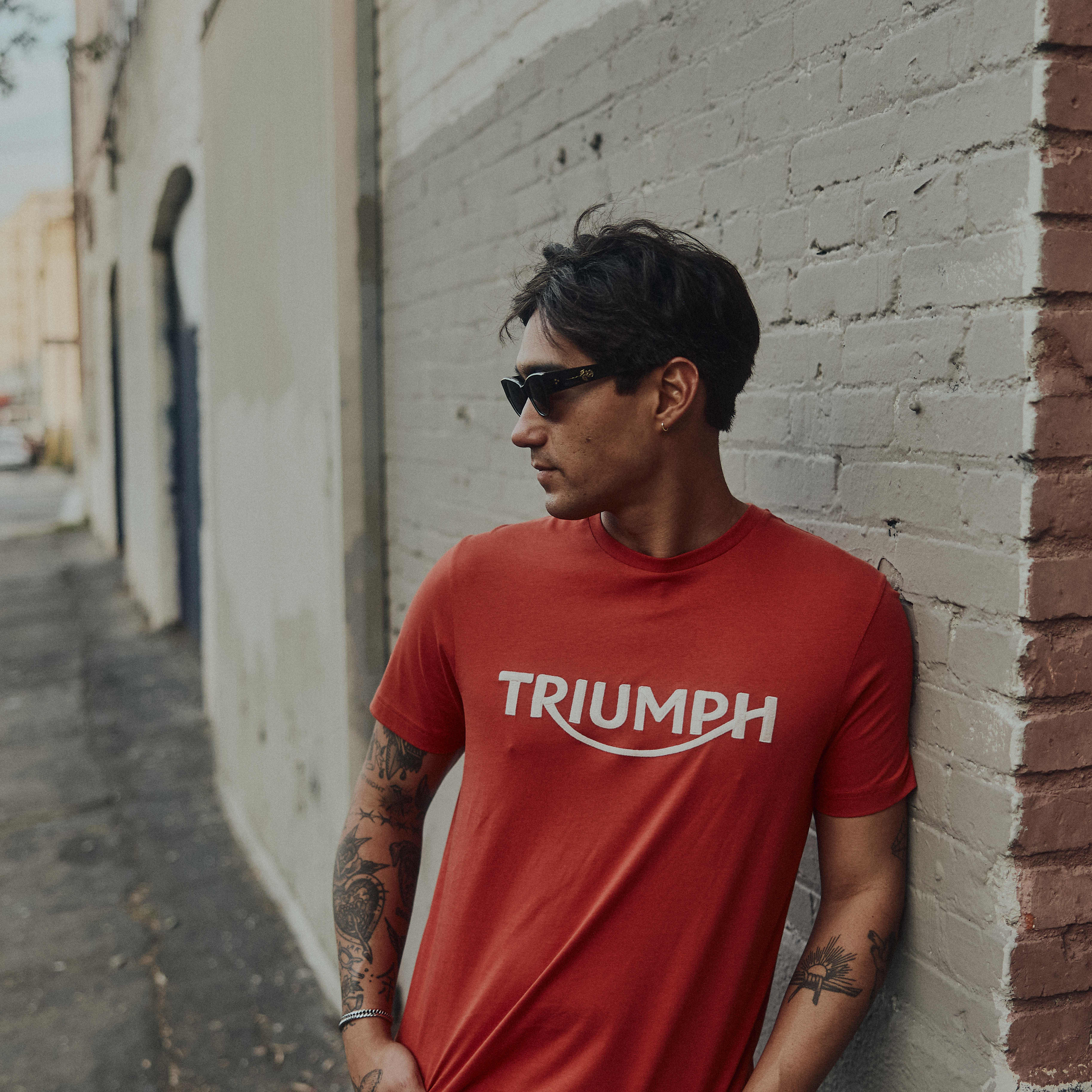 Man stood in street wearing Triumph clothing